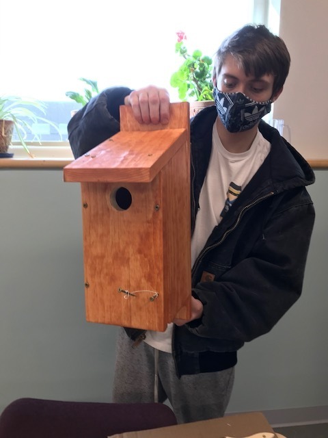 Student Holding Birdhouse